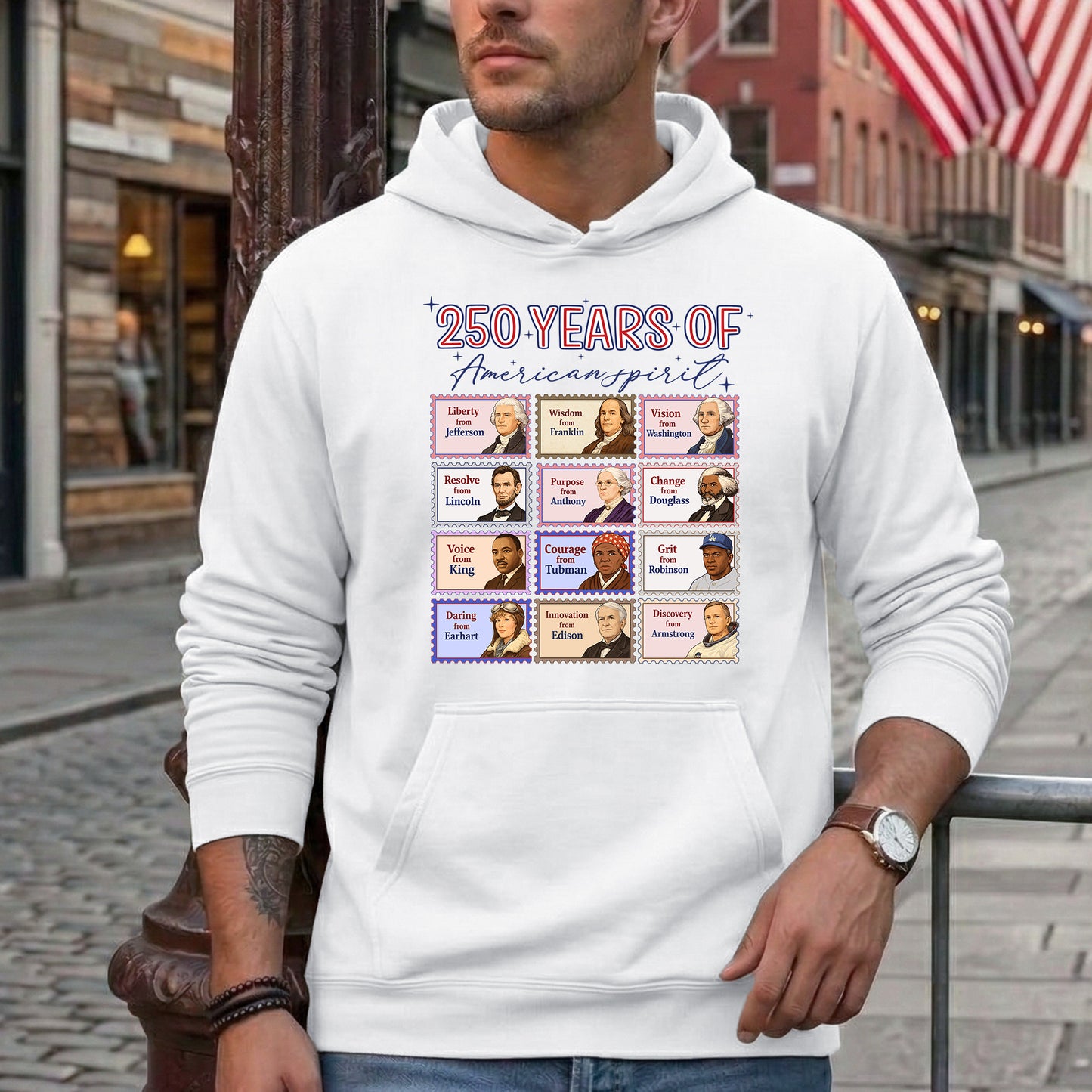 Person wearing a white hoodie with a graphic design on a city street