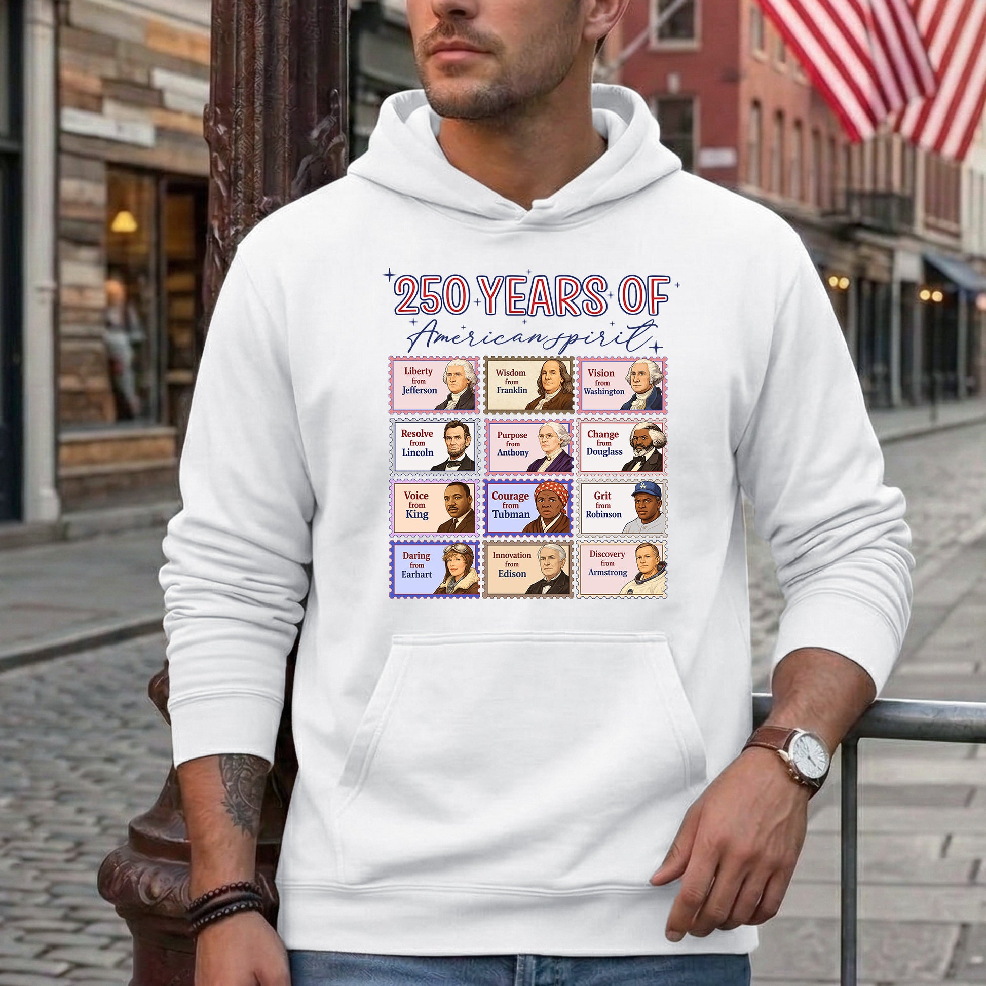 Person wearing a white hoodie with a graphic design on a city street