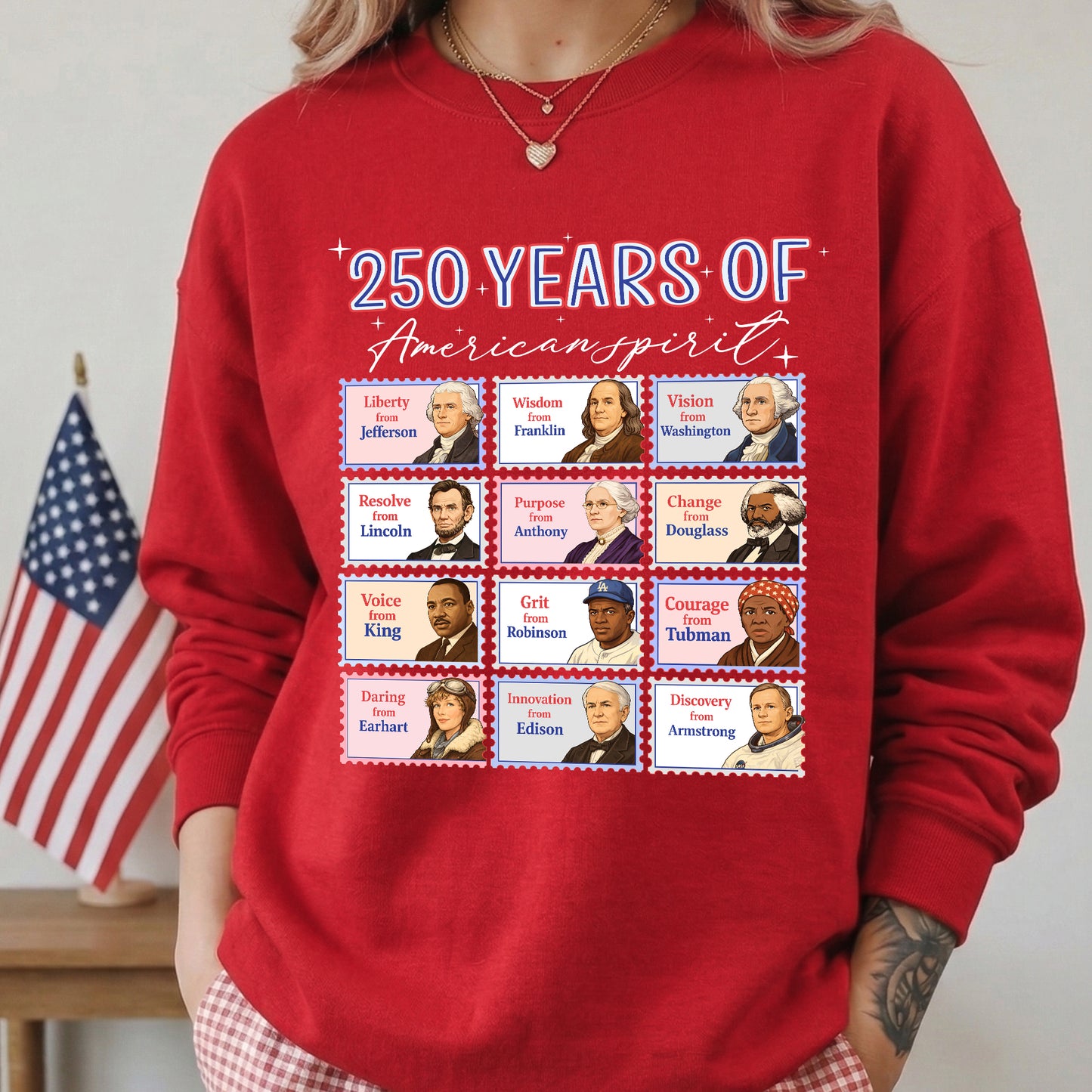 Red sweatshirt with historical figures and text '250 Years of American Spirit' in front of an American flag.