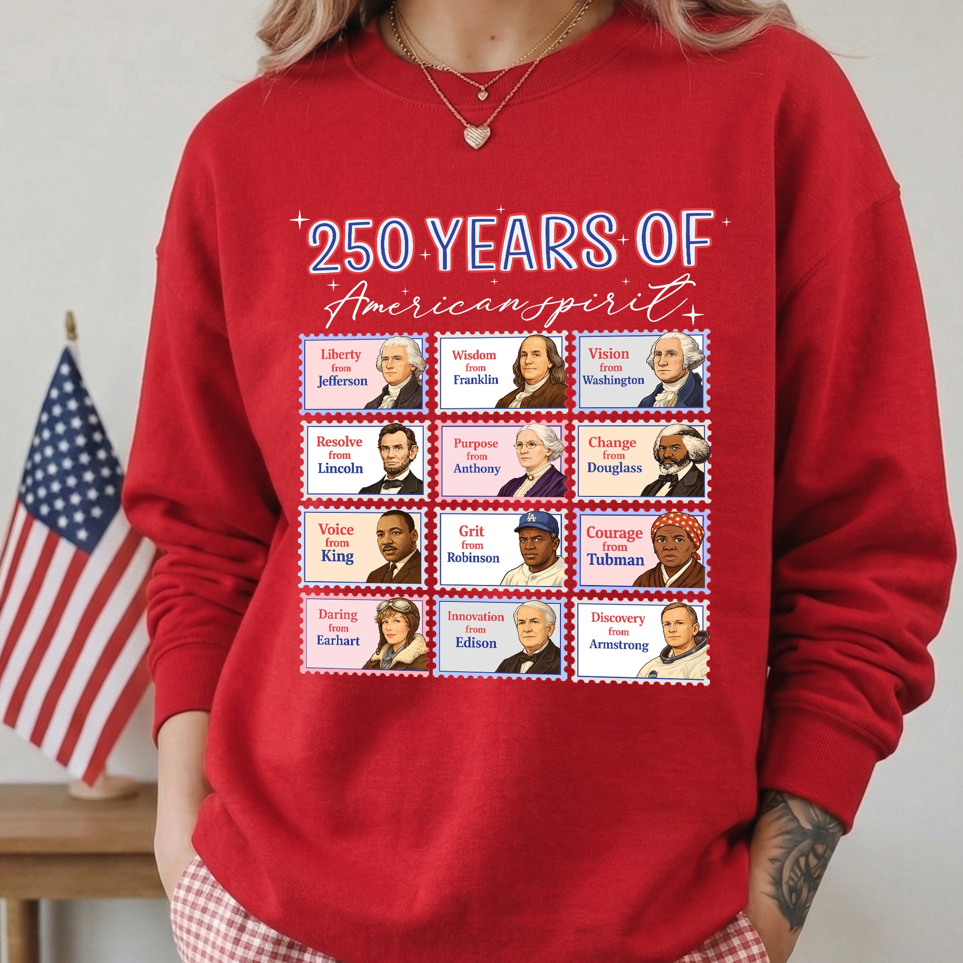 Red sweatshirt with historical figures and text '250 Years of American Spirit' in front of an American flag.