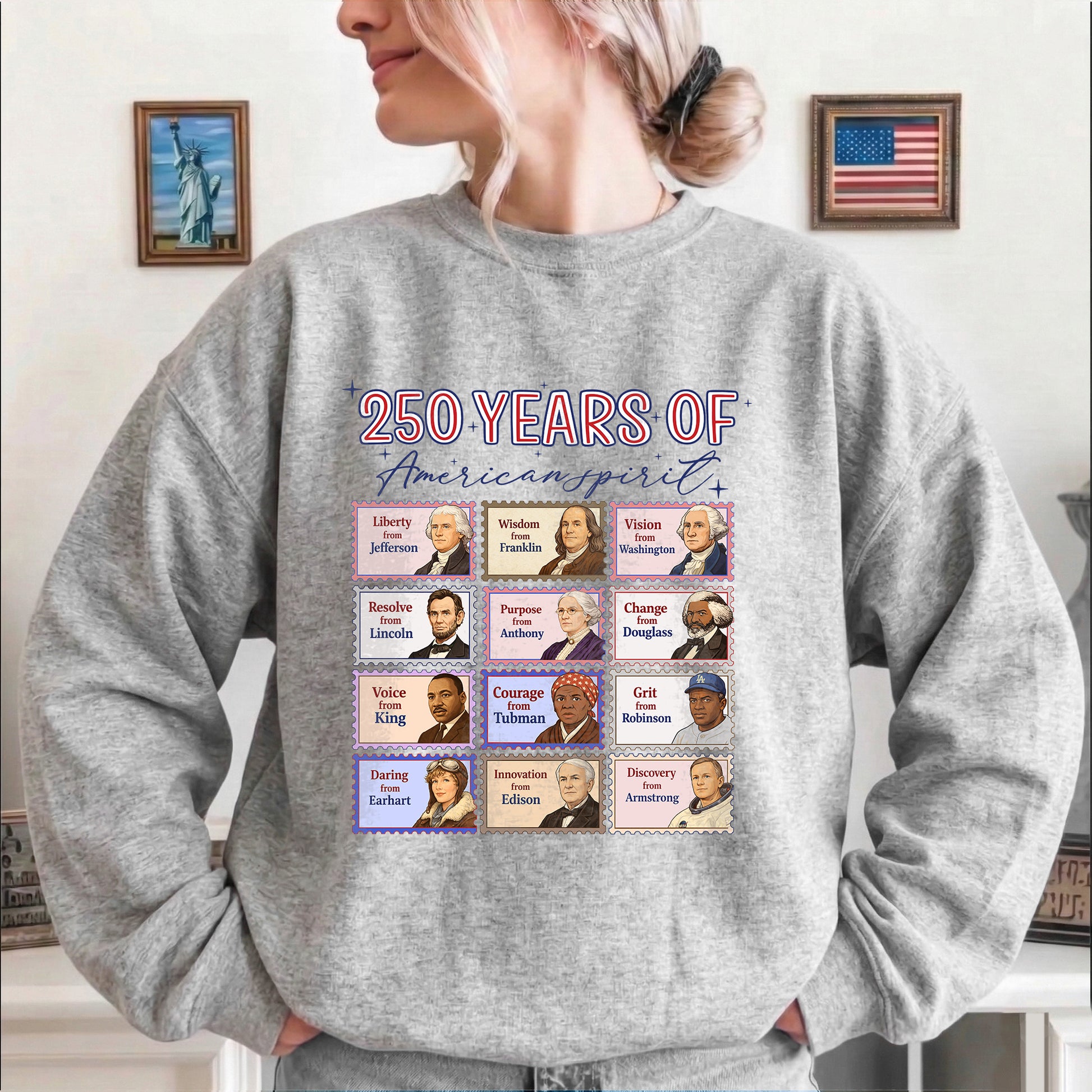 Person wearing a gray sweatshirt with '250 Years of American Spirit' design featuring historical figures.