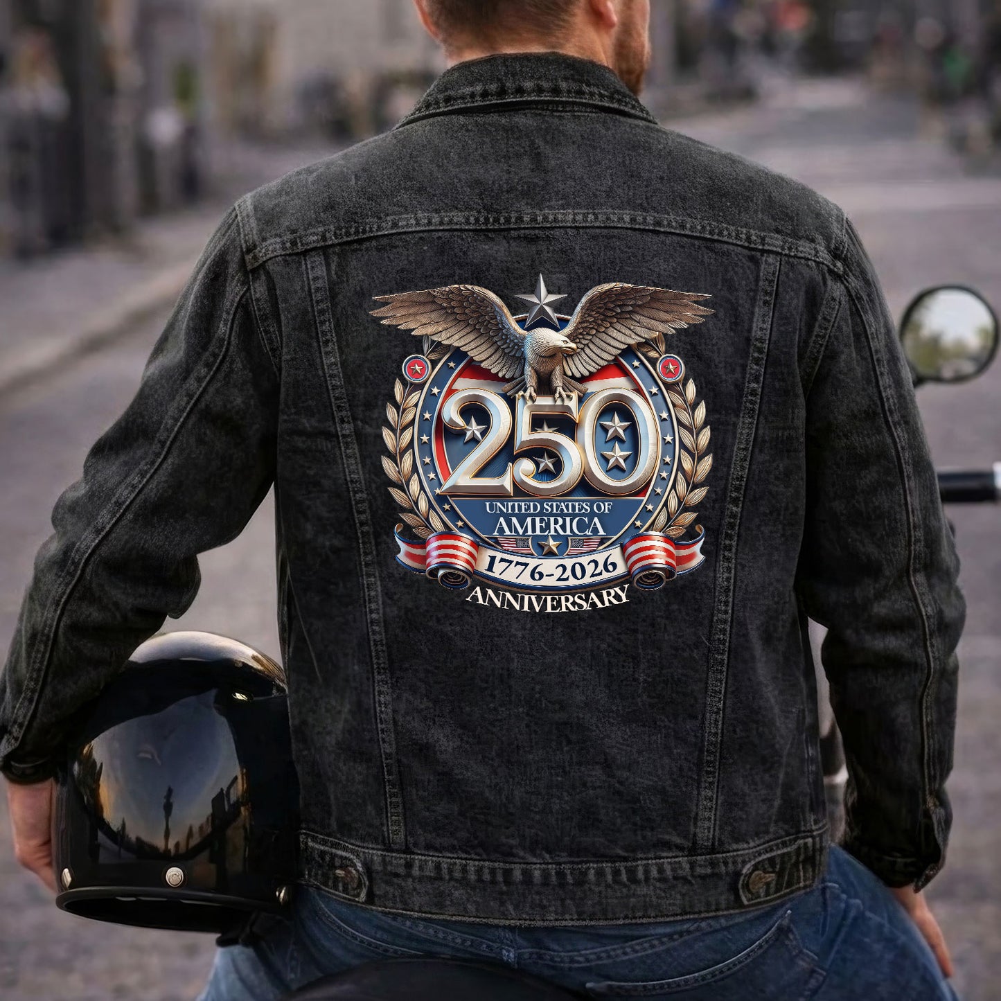 Person wearing a denim jacket with a 250th Anniversary of America design, holding a helmet.